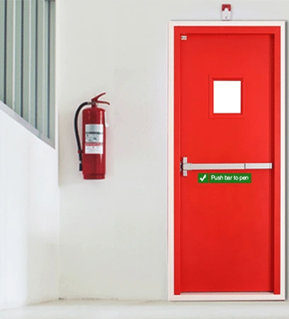 Red emergency exit door with a small window, beside a mounted fire extinguisher on a white wall